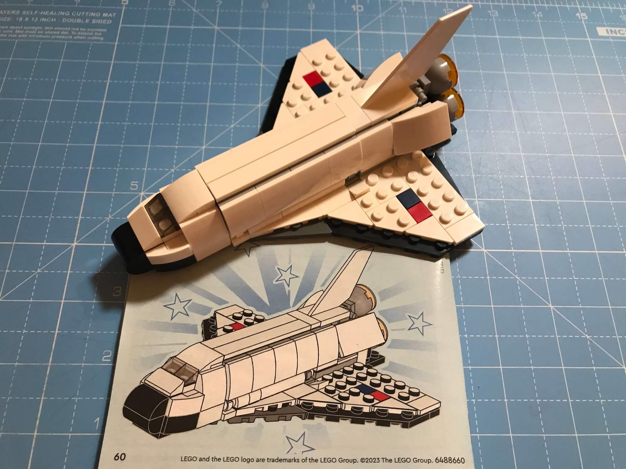 Completed Shuttle on the project mat with the instruction book.