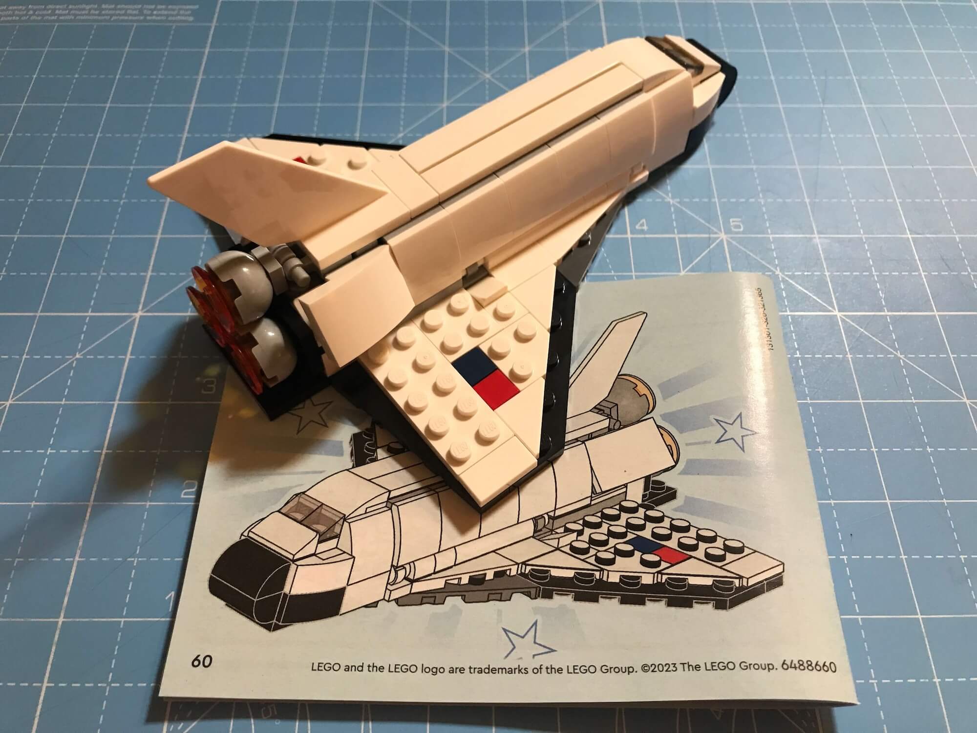 Completed Shuttle on the project mat with the instruction book.